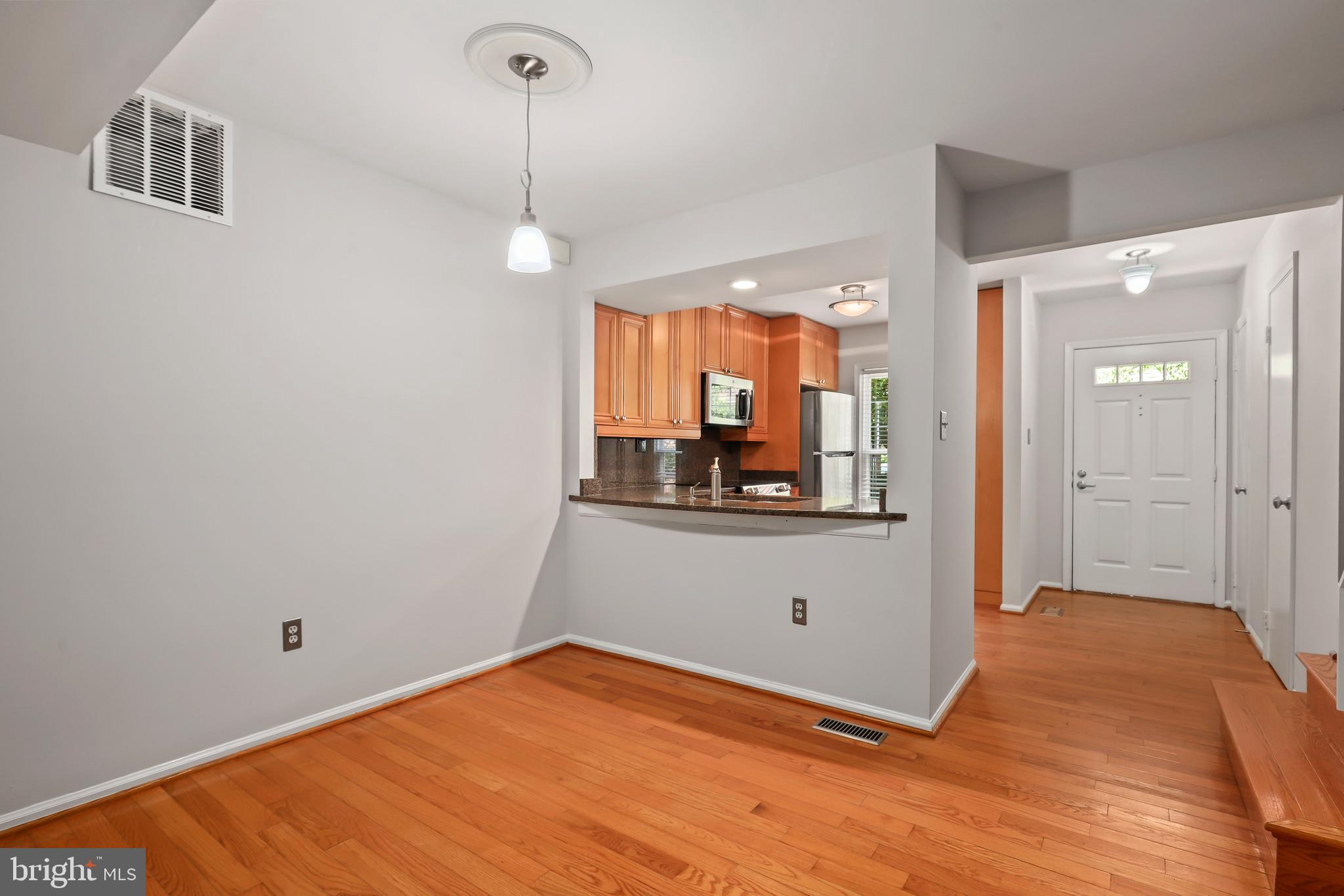 2434 South Walter Reed Drive, Unit 3 Arlington, VA 22206 - Photo 8 of 36 a view of a room with wooden floor and white walls