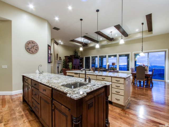 4378 Foothill Drive Bountiful, UT 84010 - Photo 8 of 46 Kitchen featuring dual islands with granite countertops, integrated sink, and wood-finish flooring
