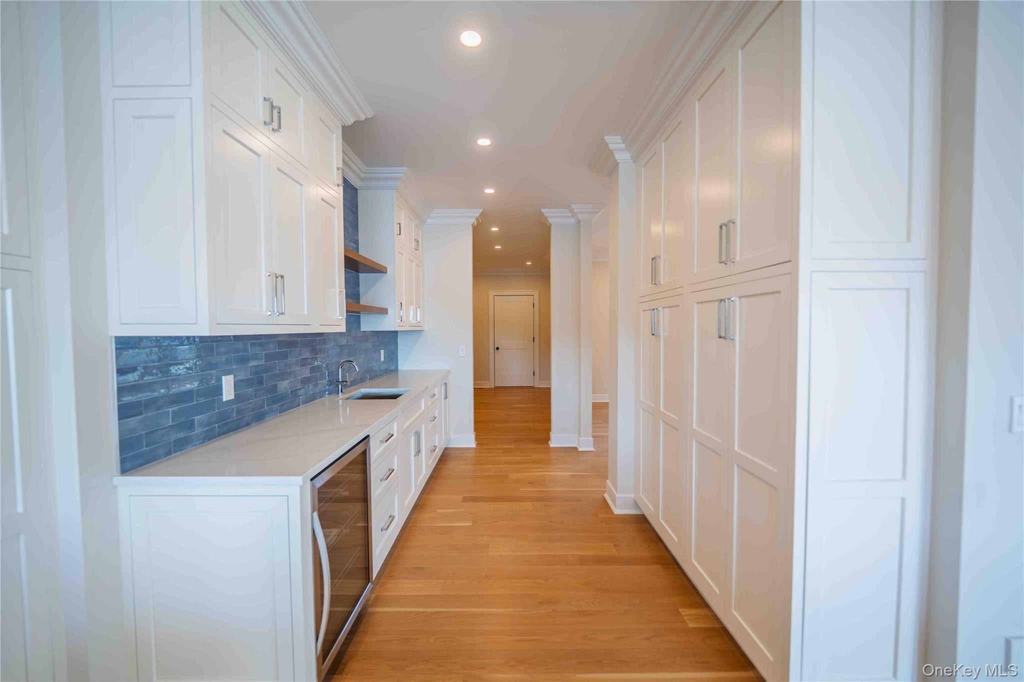 106 Cove Road Asharoken, NY 11768 - Photo 13 of 46 Kitchen featuring open shelves, recessed lighting, light wood-style flooring, wine cooler, and tasteful backsplash