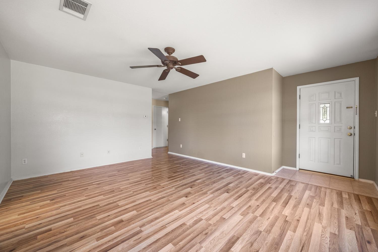 359 Spring Branch Loop Kyle, TX 78640 - Photo 3 of 17 a view of empty room with wooden floor and fan