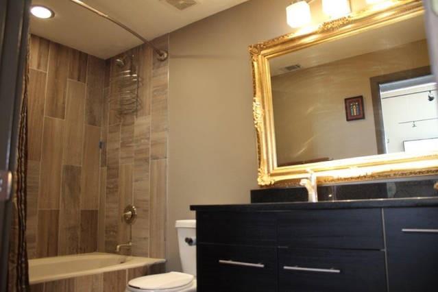 3106 Commerce Street, Unit 3104 Dallas, TX 75226 - Photo 11 of 18 a bathroom with a granite countertop sink toilet and shower