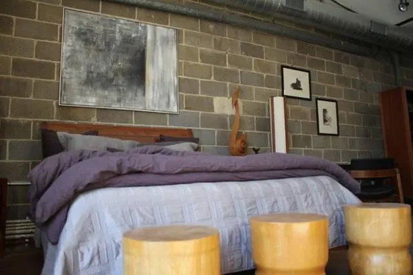 a bedroom with a bed and a mirror