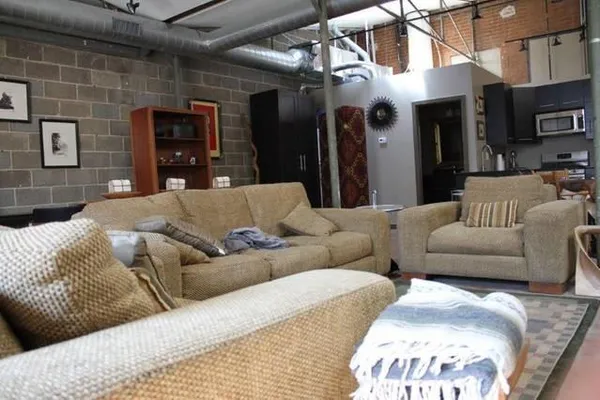 a living room with furniture and a fireplace