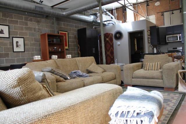 3106 Commerce Street, Unit 3104 Dallas, TX 75226 - Photo 15 of 18 a living room with furniture and a fireplace