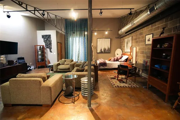 a living room with furniture a flat screen tv and rug