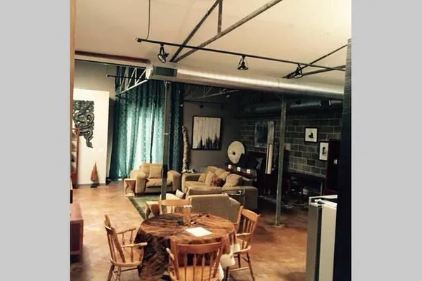 a dining room with furniture and a window