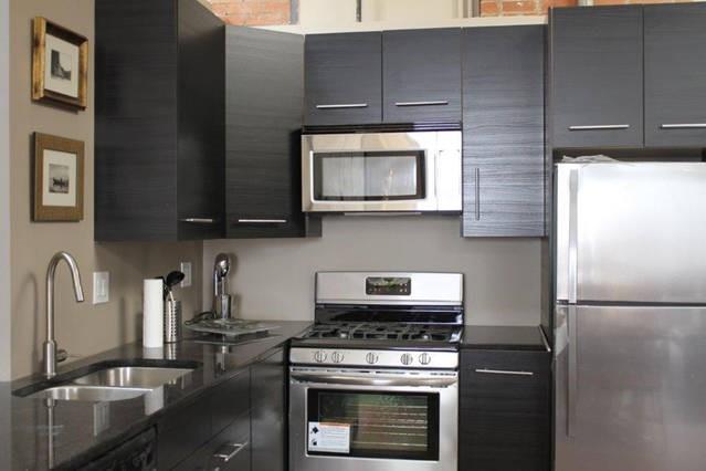 3106 Commerce Street, Unit 3104 Dallas, TX 75226 - Photo 8 of 18 a kitchen with stainless steel appliances granite countertop a stove a refrigerator and a microwave
