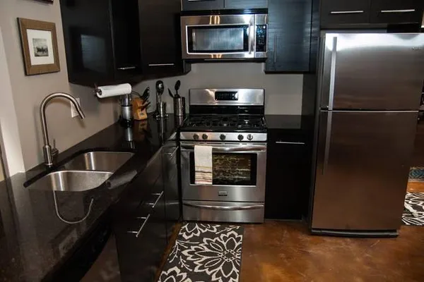 a kitchen with a refrigerator stove and sink