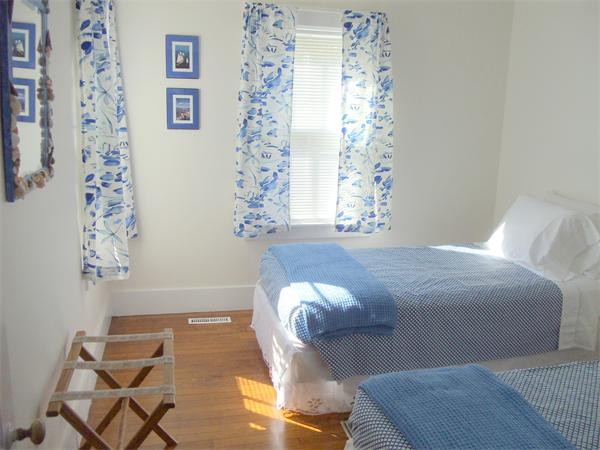 14 Bayview Road Marion, MA 02738 - Photo 11 of 22 a bedroom with a bed and a chandelier