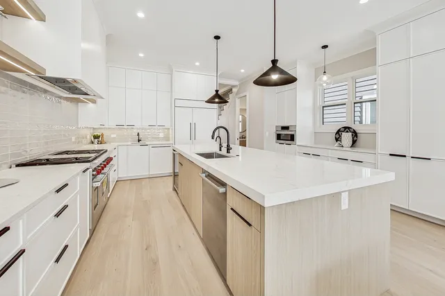 a kitchen with a sink stainless steel appliances and window