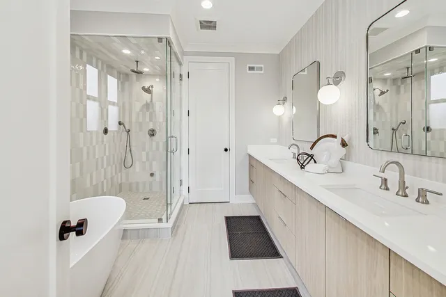 a bathroom with a double vanity sink mirror double and shower
