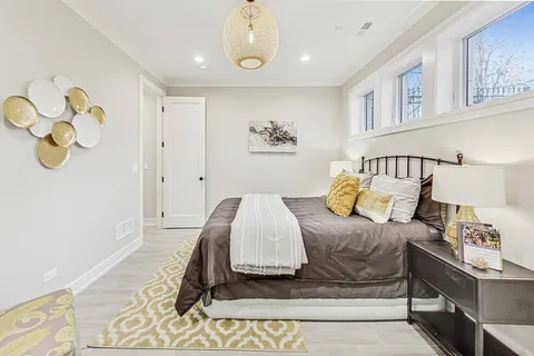 a bedroom with a bed and painting on the wall