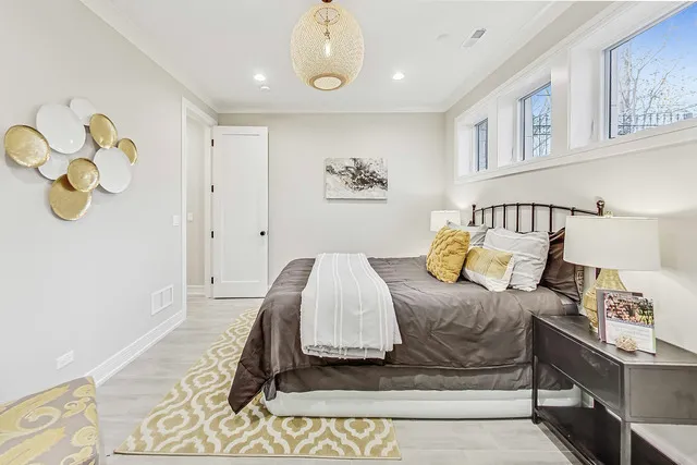 a bedroom with a bed and painting on the wall