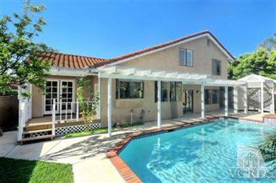 12522 Spring Creek Road Moorpark, CA 93021 - Photo 16 of 20 a front view of a house with a garden and porch