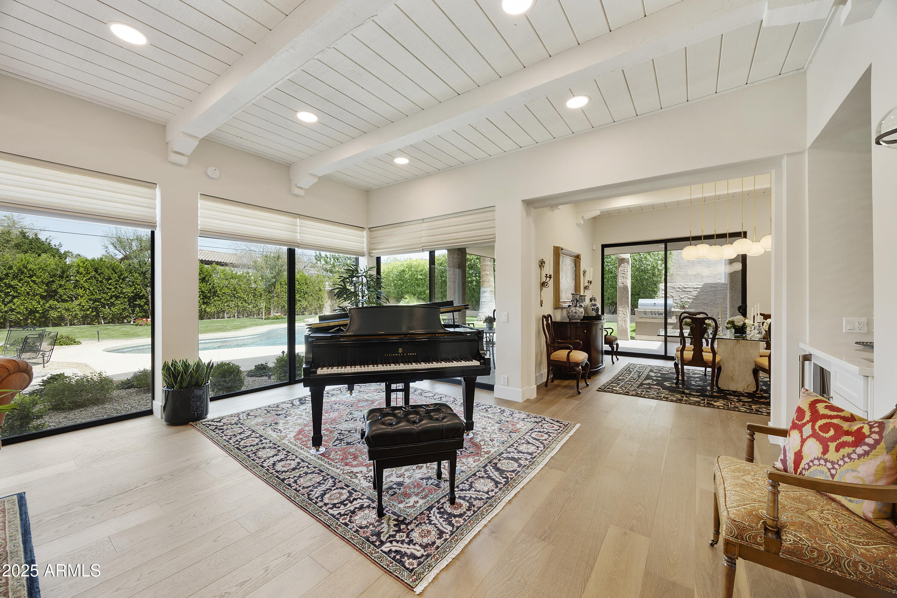 4436 East Camelback Road, Unit 37 Phoenix, AZ 85018 - Photo 1 of 55 a living room with furniture a rug and a floor to ceiling window