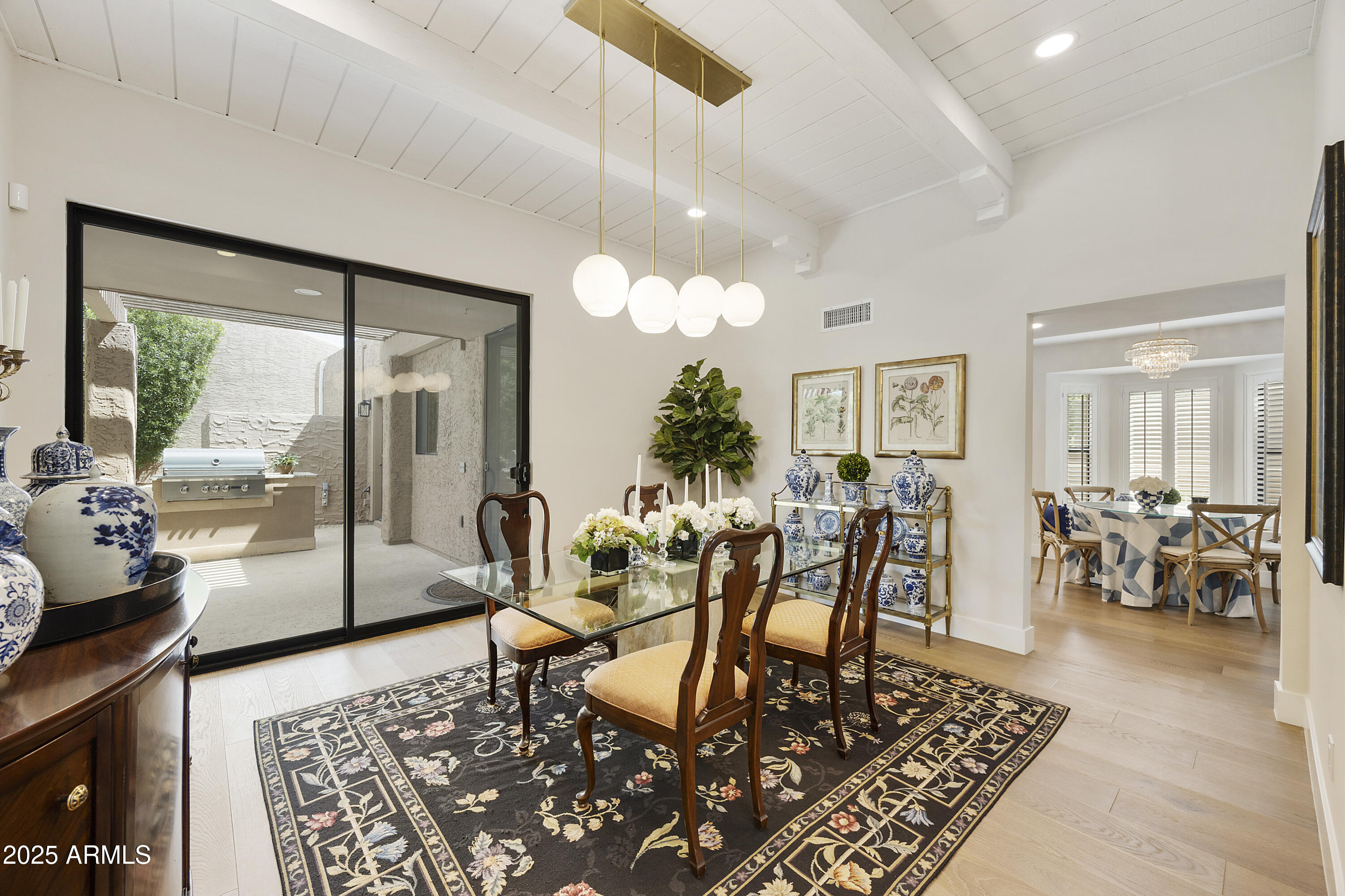 4436 East Camelback Road, Unit 37 Phoenix, AZ 85018 - Photo 11 of 55 a dining room with furniture a rug and a chandelier