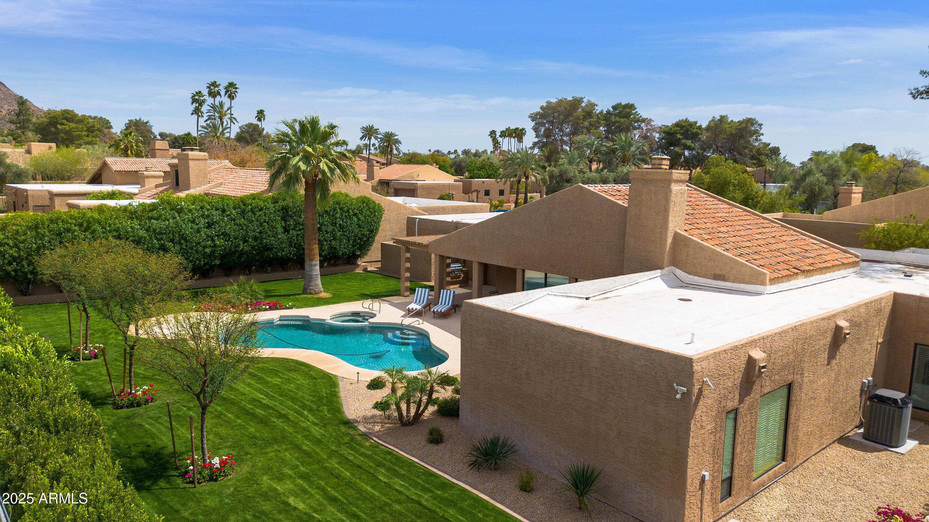 4436 East Camelback Road, Unit 37 Phoenix, AZ 85018 - Photo 14 of 55 a view of a house with swimming pool and a yard
