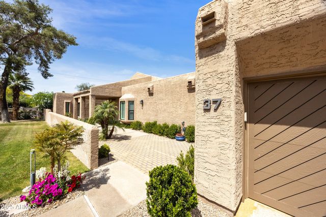 a dining room with furniture and a floor to ceiling window