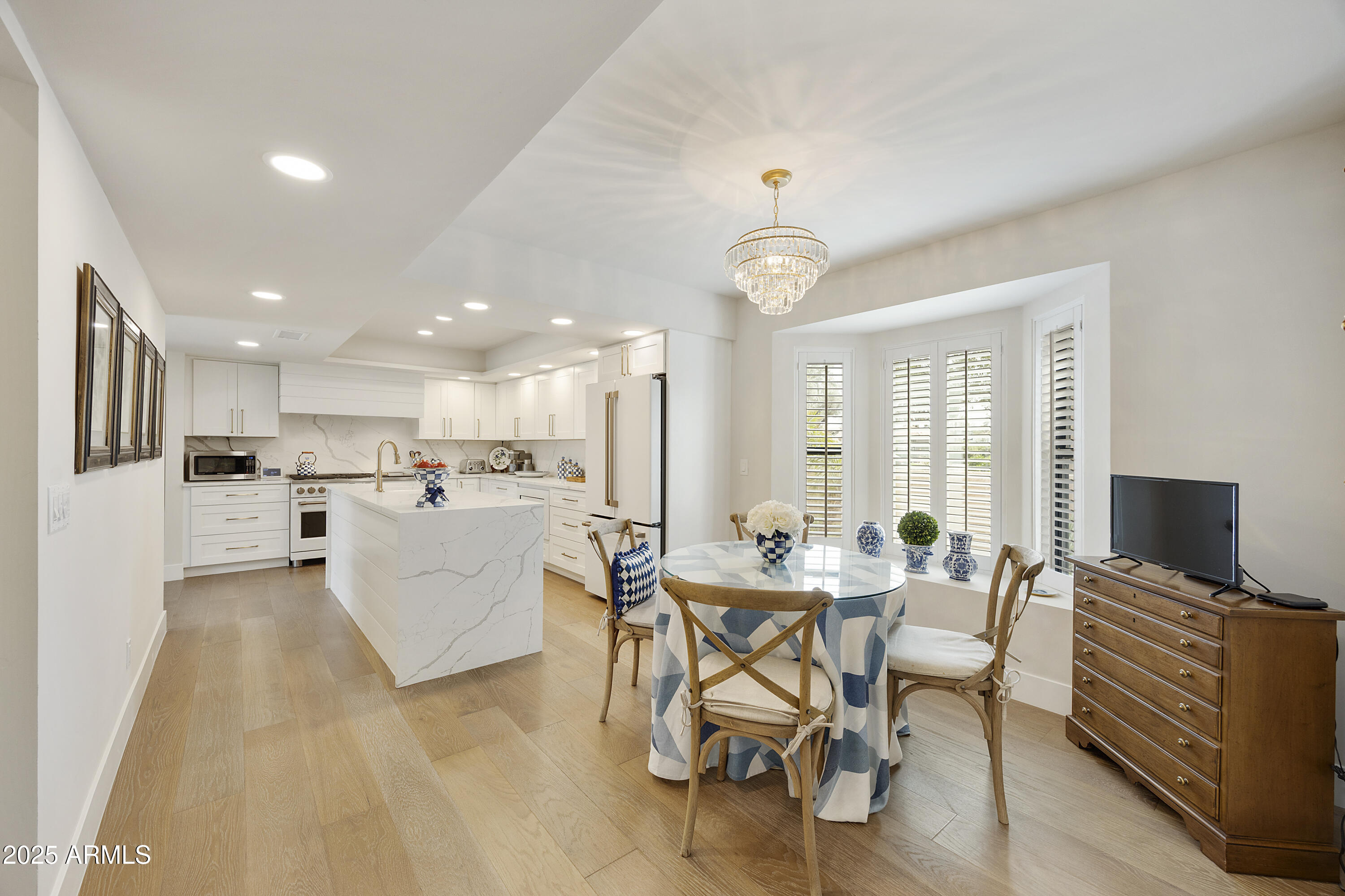 4436 East Camelback Road, Unit 37 Phoenix, AZ 85018 - Photo 21 of 55 a view of a dining room with furniture a kitchen and chandelier