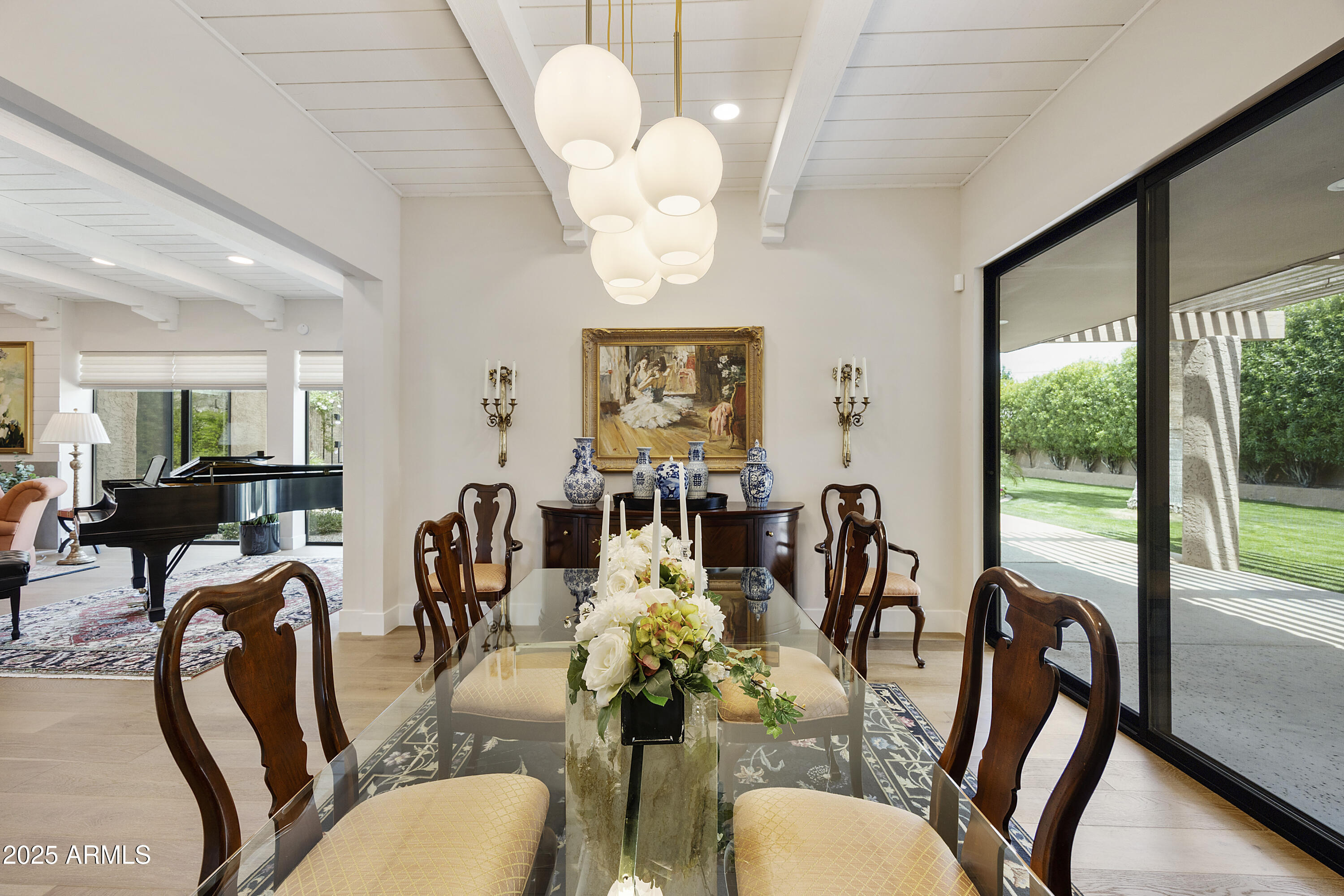 4436 East Camelback Road, Unit 37 Phoenix, AZ 85018 - Photo 23 of 55 a view of a dining room with furniture a chandelier and large windows