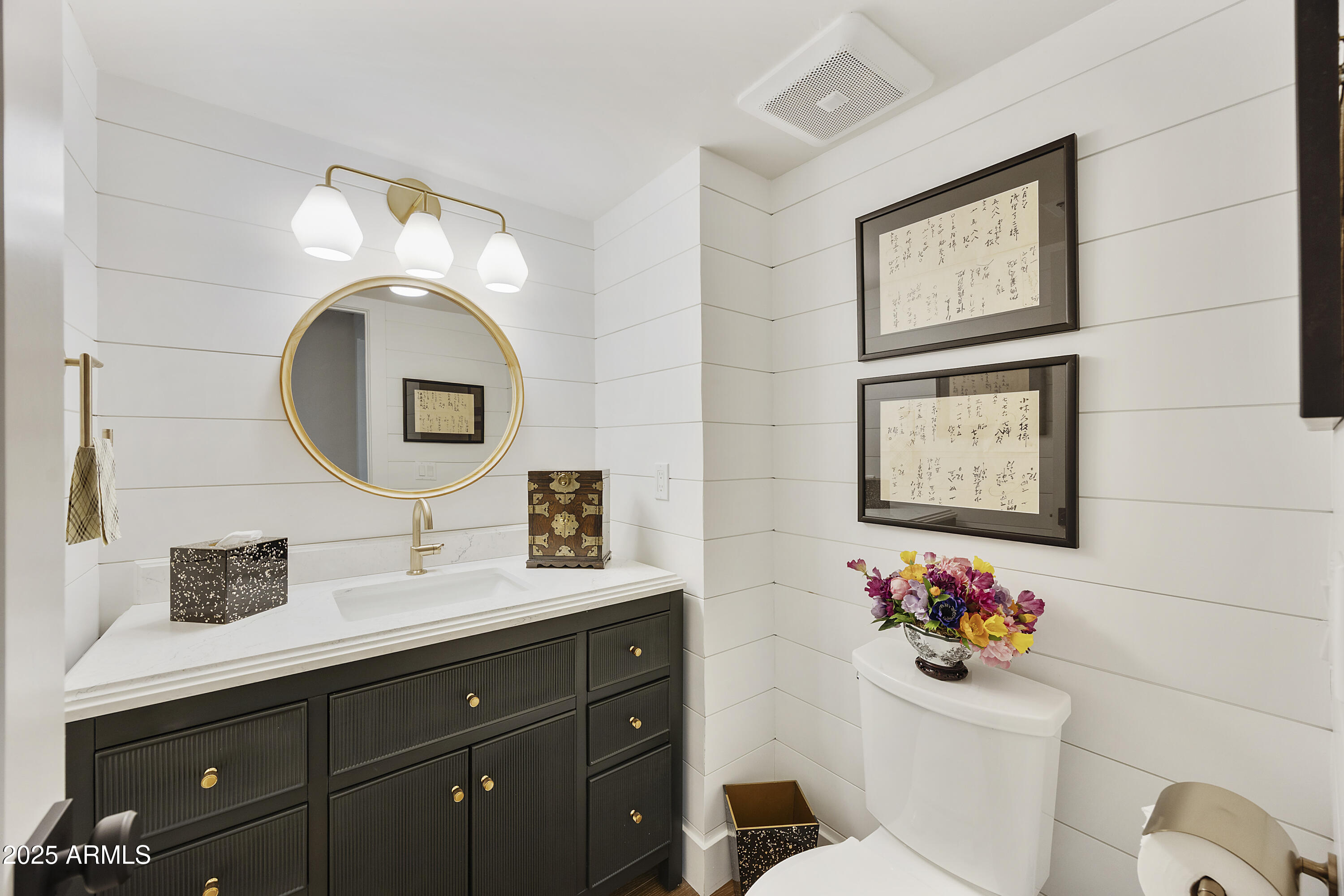 4436 East Camelback Road, Unit 37 Phoenix, AZ 85018 - Photo 31 of 55 a bathroom with a toilet a sink and a mirror