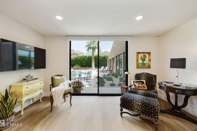 a view of a dining room with furniture a kitchen and chandelier