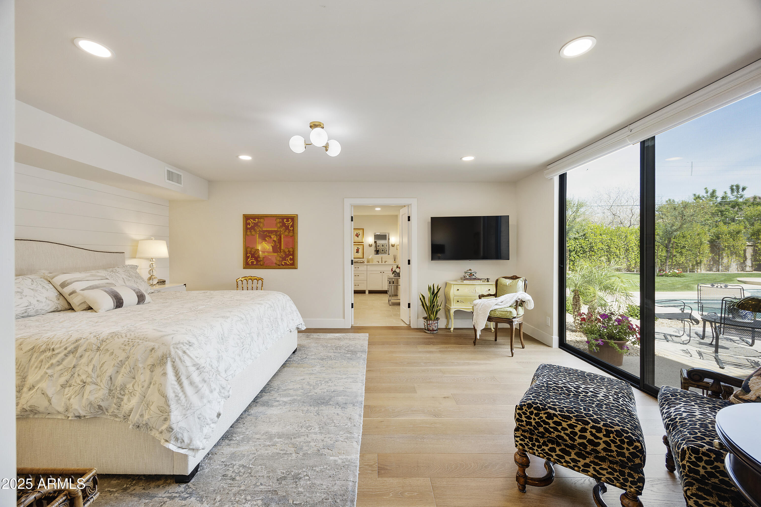 4436 East Camelback Road, Unit 37 Phoenix, AZ 85018 - Photo 10 of 55 a spacious bedroom with a bed and a flat screen tv