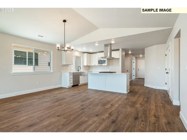 a view of a room wooden floor and windows