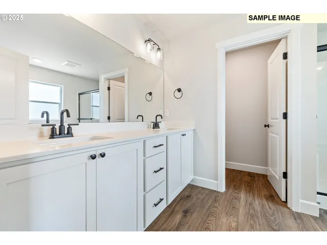 a view of empty room with wooden floor and windows