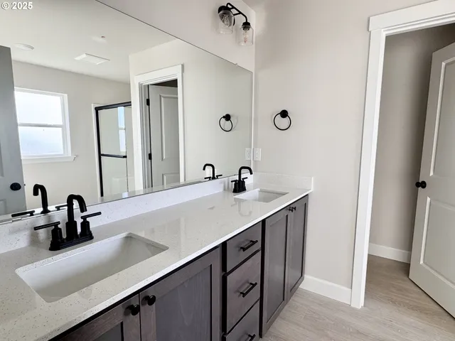 a bathroom with a white toilet sitting next to a window