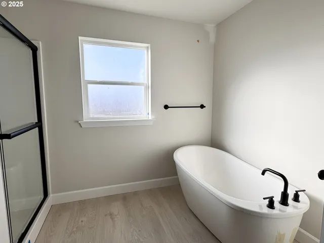 a view of a backyard with wooden fence