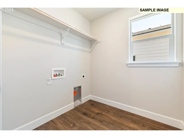 a kitchen with stainless steel appliances granite countertop a sink a stove and a wooden floors