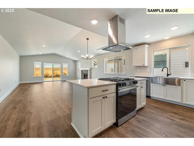 a kitchen that has a sink and a stove