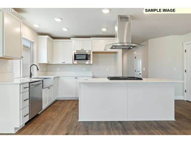 a view of a kitchen with wooden floor and a kitchen