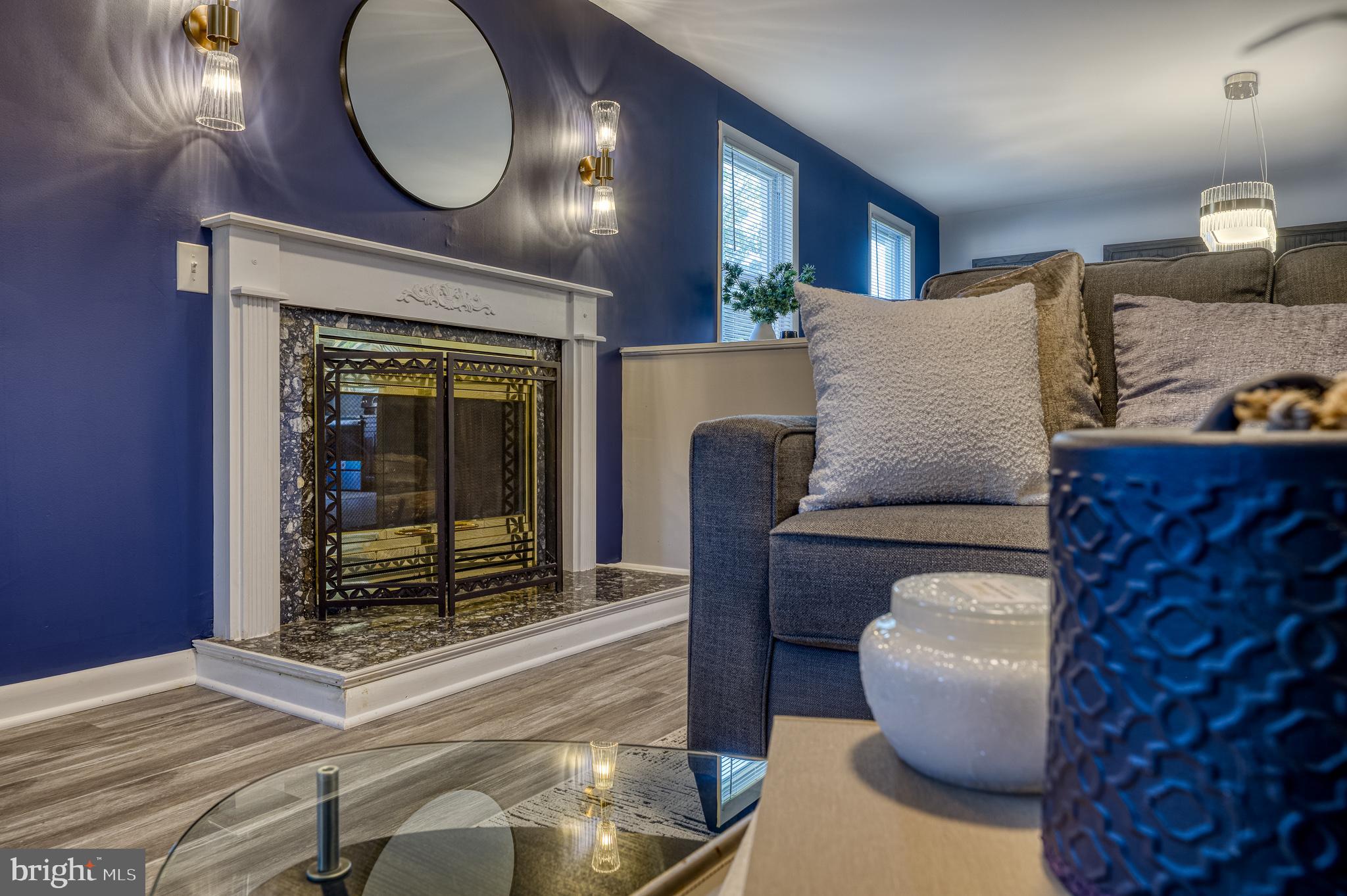 510 Middle River Road Baltimore, MD 21220 - Photo 5 of 65 a living room with furniture a lamp and a fireplace