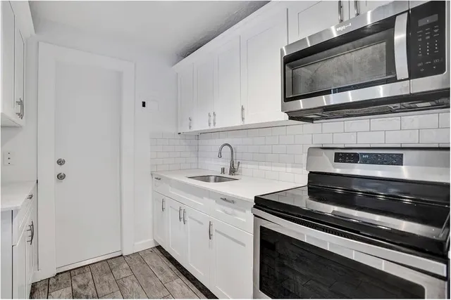 a kitchen with a stove and a microwave