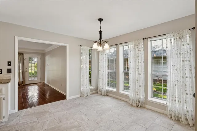 a view of a hallway with wooden floor and a livingroom