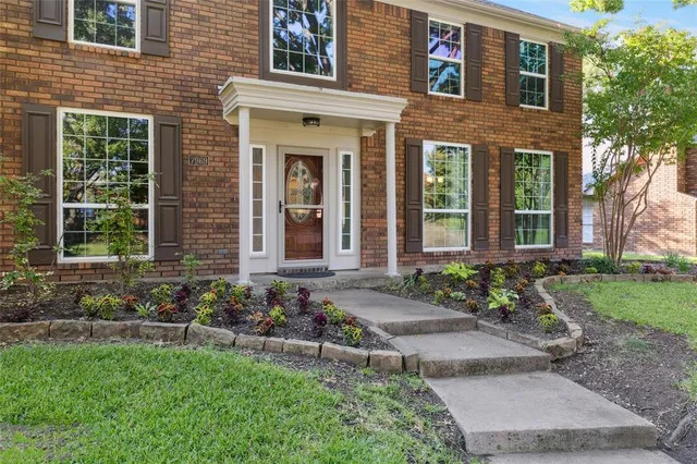 a front view of a house with garden