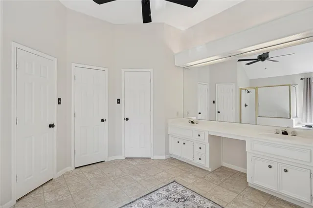a view of a kitchen with white cabinets