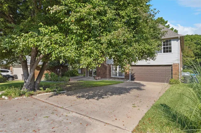 a front view of a house with yard and green space