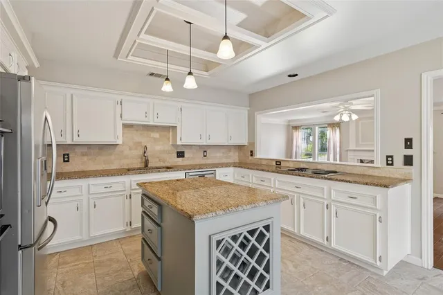 a kitchen with a sink window and cabinets