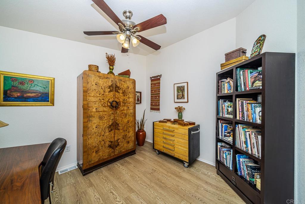 4747 Oak Crest Road, Unit 8 Fallbrook, CA 92028 - Photo 20 of 36 a living room with couch and a book shelf