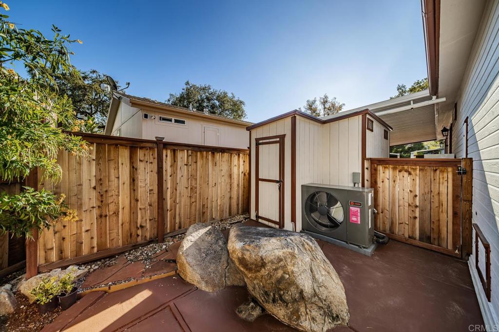 4747 Oak Crest Road, Unit 8 Fallbrook, CA 92028 - Photo 24 of 36 a bedroom with furniture and a fireplace