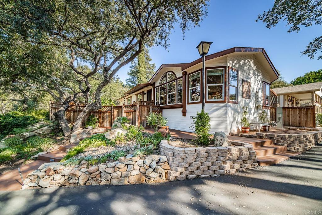 4747 Oak Crest Road, Unit 8 Fallbrook, CA 92028 - Photo 27 of 36 a front view of a house with a yard