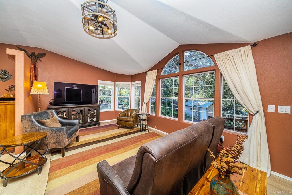 4747 Oak Crest Road, Unit 8 Fallbrook, CA 92028 - Photo 4 of 36 a living room with furniture a flat screen tv and a large window