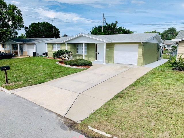 3700 Cambridge Street New Port Richey, FL 34652 - Photo 1 of 1 front view of a house with a yard