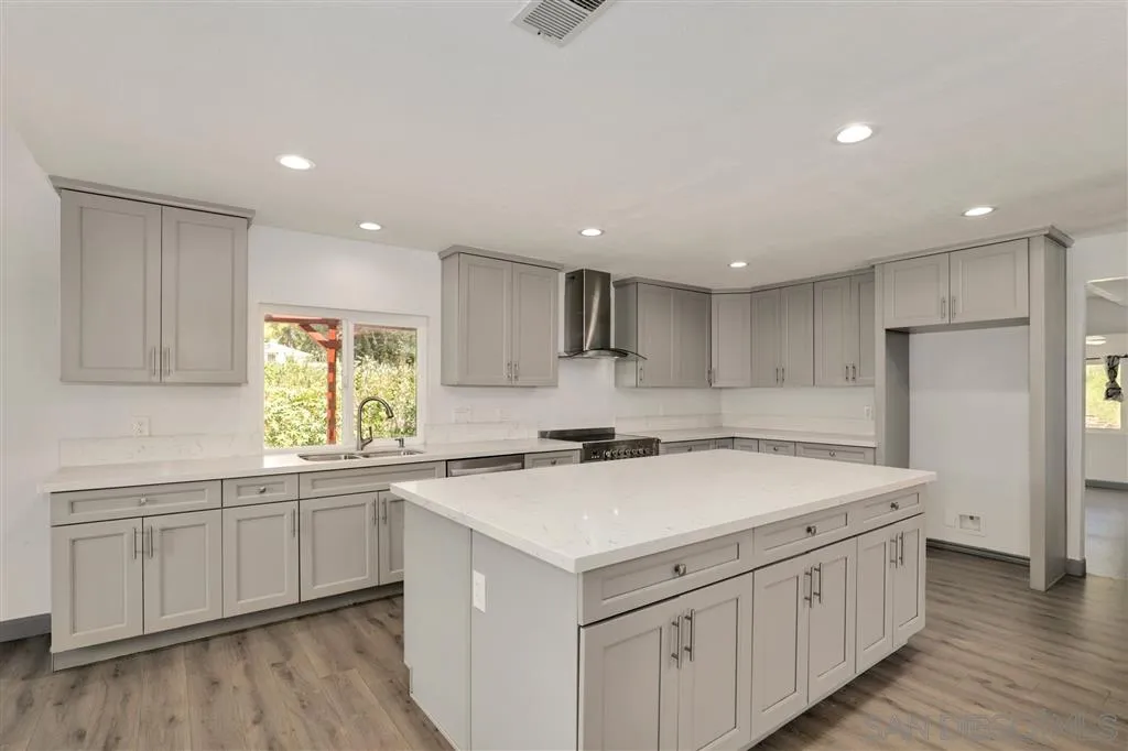 15157 Crocker Road Poway, CA 92064 - Photo 5 of 22 a kitchen that has a sink a stove and a refrigerator