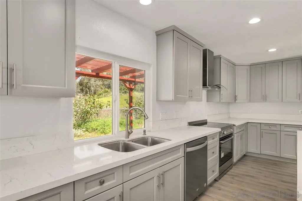 15157 Crocker Road Poway, CA 92064 - Photo 6 of 22 a kitchen with a sink stove and cabinets