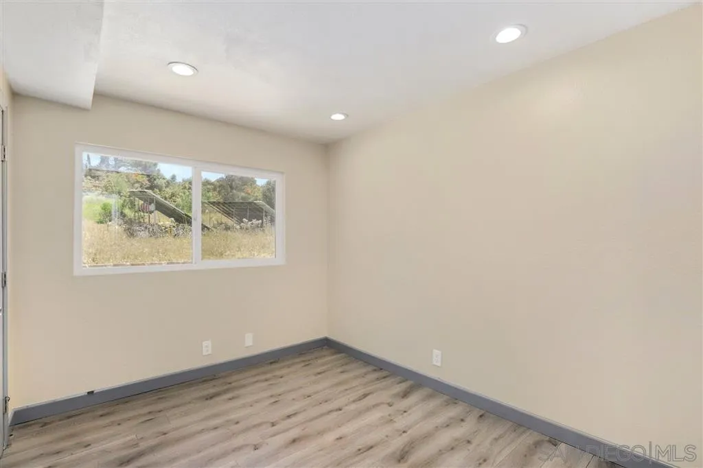 15157 Crocker Road Poway, CA 92064 - Photo 10 of 22 an empty room with wooden floor and windows
