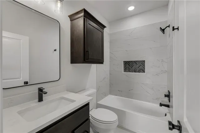 a bathroom with a sink a toilet and a bathtub